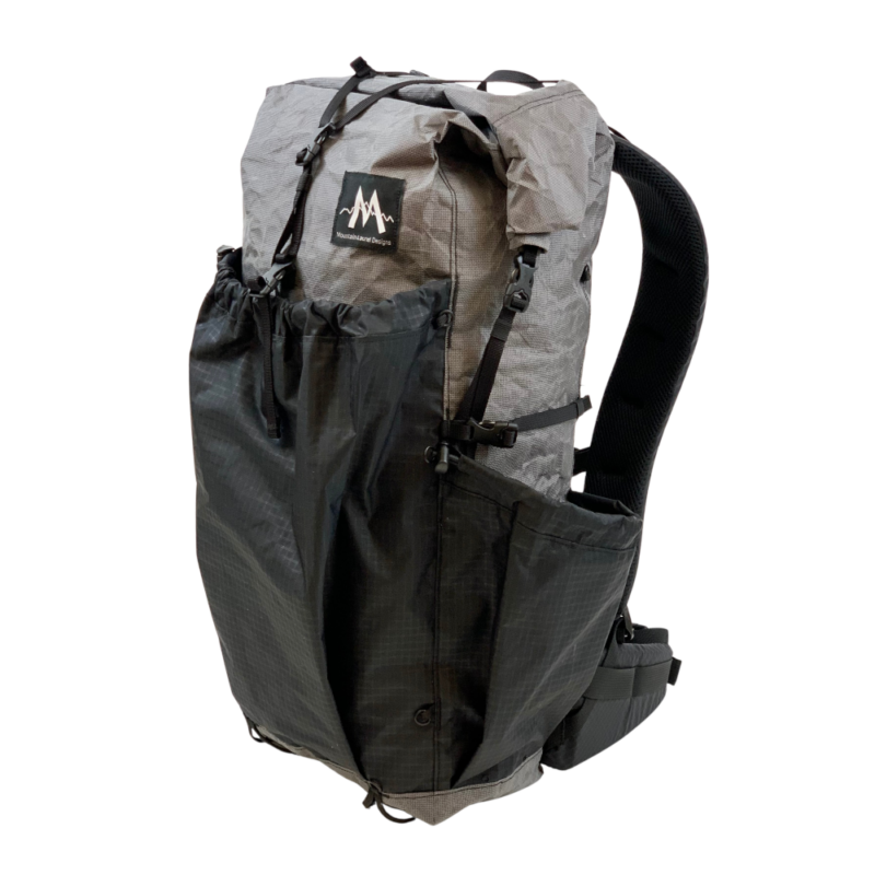 A 3/4 side view of the Burn 36L pack showing side pockets, front pocket, and shoulder straps