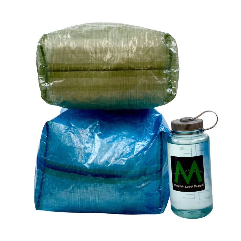 Flat bottom of the DCF Pack Liner. A small Green ontop of a Blue Large to show size difference.