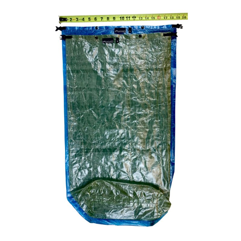 A small green and large blue DCF pack liner stacked by a measuring tape to show size difference.