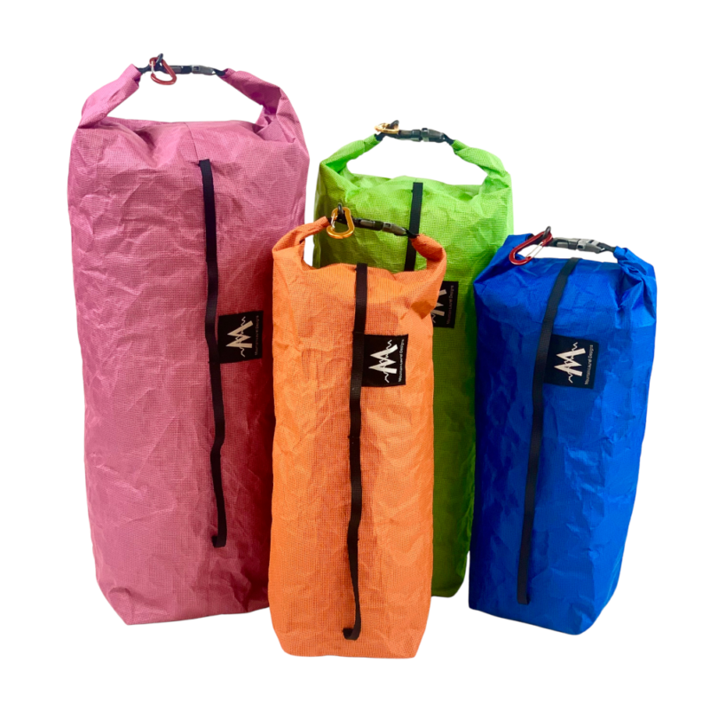 Ultra Bike Dry Bags from left to right: Fuchsia Raspberry Large, Medium Lime, Medium Mandarin, Small Blue