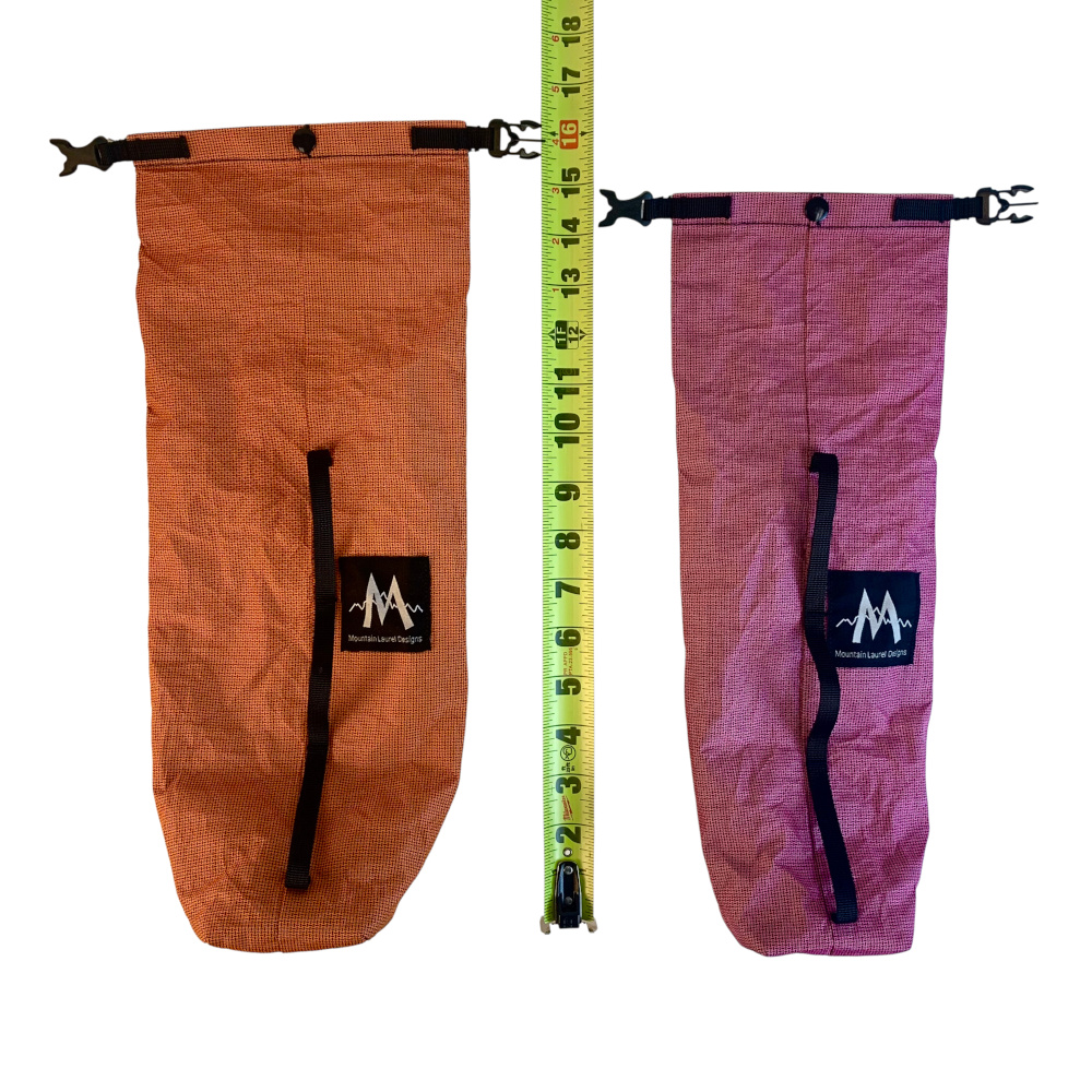 A 2.5L (left) and 1.6L (right) dry fork bag sit next to a measuring tape, showing their approximate length.