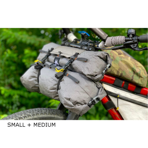 Image shows a Small and Medium dry bag on the handlebars of a bicycle.