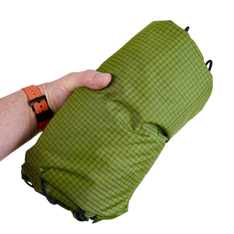 The Super Core 38L rolled up in a persons hand.